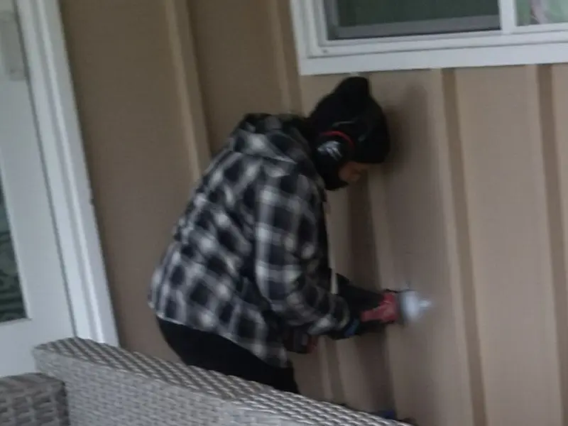 Professional electrician installing an exterior outlet in Lacey